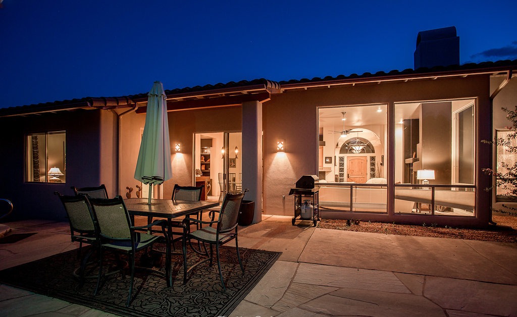 Twilight courtyard with flagstone terrace and outdoor dining