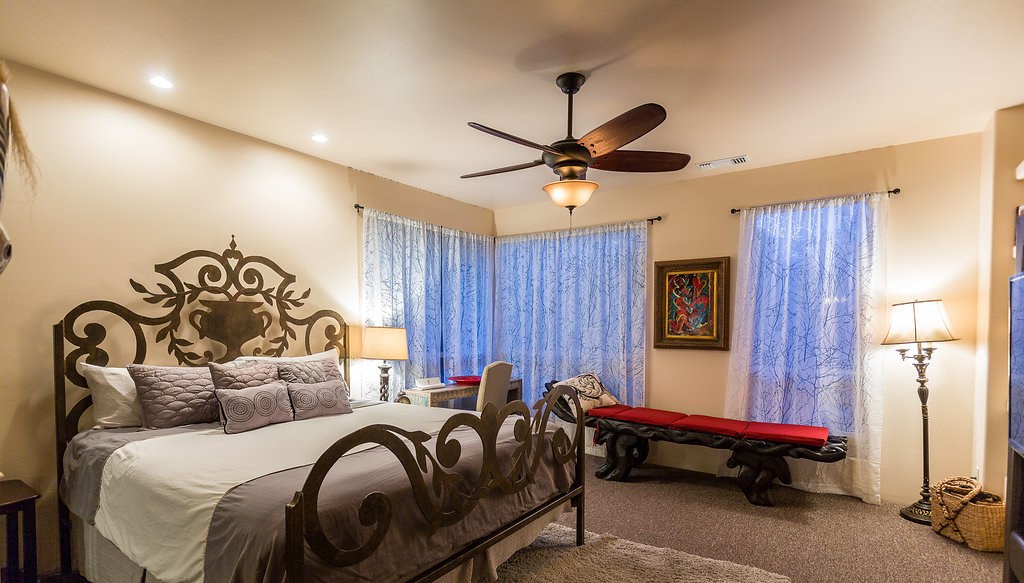 Primary bedroom with ornate iron bed